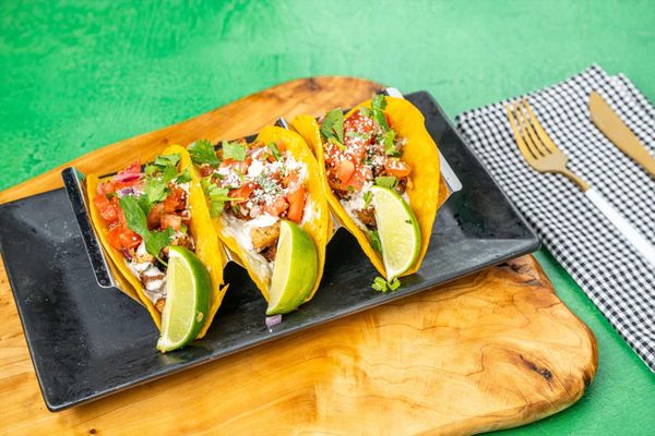 Taco Way signature dishes Tacos De BirriaChile Queso and ChipsCaribbean Chicken Tacos
